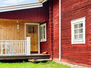 A wooden house with a porch, a door, and a window. - 4 Person Holiday Home in Tallberg (Tallberg)