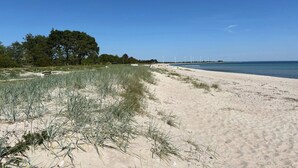 A sandy beach with dunes and sparse vegetation. - 5 Star Holiday Home in Sydals (Sydals)