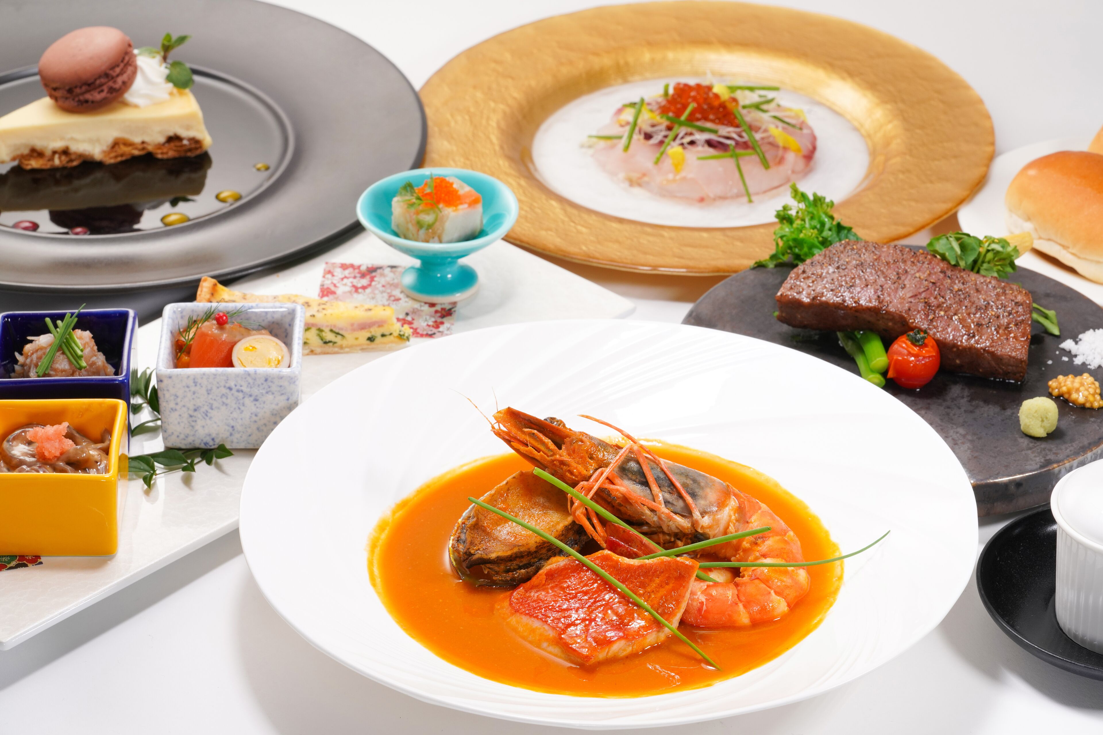 A variety of dishes on a table, including seafood, a dessert, and a meat dish.