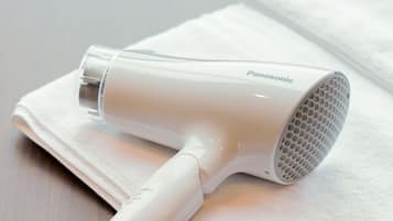 A Panasonic hair dryer on a white towel.