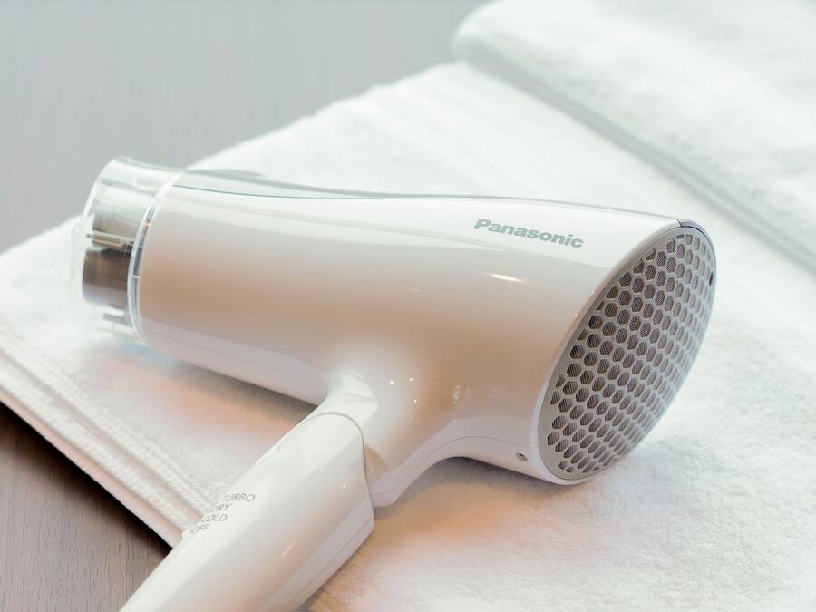 A Panasonic hair dryer on a white towel.