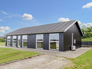 Een modern gebouw met een schuin dak en grote ramen.