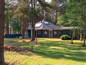 A house with a dark exterior, a sloped roof, and a small front porch. - 4 Star Holiday Home in Laeso (Læsø)