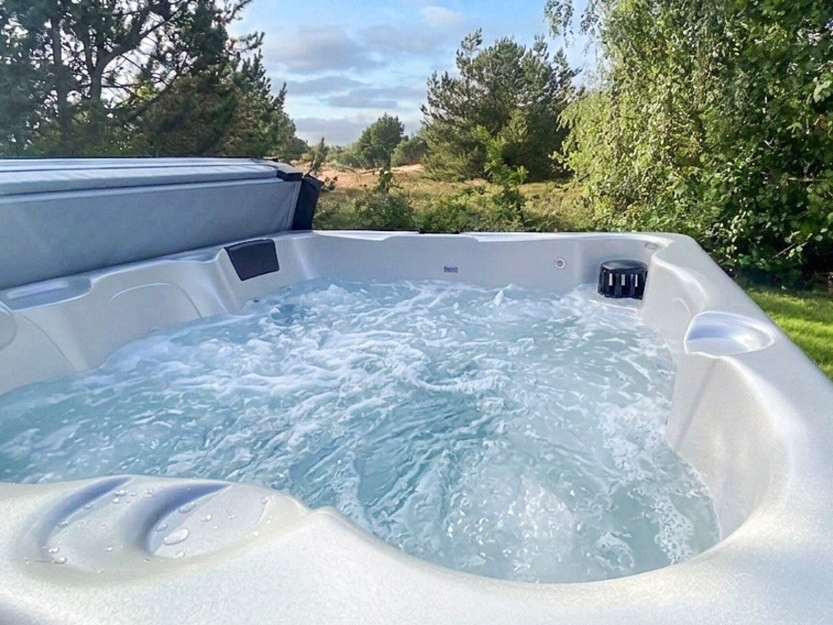 A hot tub with a clear view of the surrounding landscape.