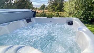 A hot tub with a clear view of the surrounding landscape.