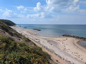 A coastal beach with a rocky shoreline, clear skies, and calm sea. - 4 Star Holiday Home in Vejby (Vejby)