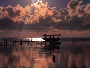 A beach scene with a wooden pier and a bench. - 6 Person Holiday Home in Hadsund (Hadsund)