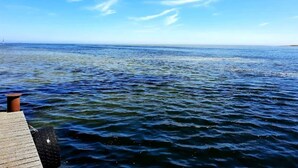 A wooden pier extending into a calm sea under a clear sky. - 6 Person Holiday Home in Hadsund (Hadsund)