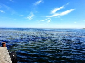 A wooden pier extending into a calm sea under a clear sky. - 6 Person Holiday Home in Hadsund (Hadsund)