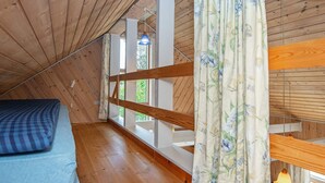 A room with a wooden ceiling, a bunk bed, a window with curtains, and a hanging light fixture. - 6 Person Holiday Home in Skjern (Skjern)