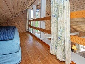 A room with a wooden ceiling, a bunk bed, a window with curtains, and a hanging light fixture. - 6 Person Holiday Home in Skjern (Skjern)