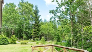 A wooden deck with a view of a lush green landscape and trees. - 8 Person Holiday Home in Skanes Fagerhult (Skånes Fagerhult)