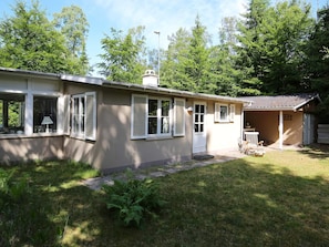 A single-story house with a front porch, a small attached garage, and a well-maintained lawn. - 4 Person Holiday Home in Frederiksvaerk (Frederiksvaerk)