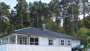 A single-story house with a tiled roof, white exterior, and a covered porch. - 4 Star Holiday Home in Sandane (Gloppen)