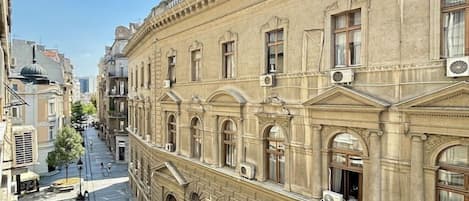 A historic building with classical architecture, featuring arched windows and decorative moldings.