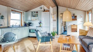 A cozy interior with a kitchen, dining area, and seating space.