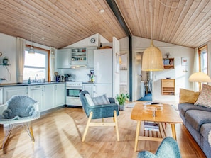 A cozy interior with a kitchen, dining area, and seating space.