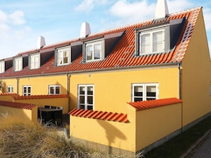 A yellow building with a red-tiled roof and multiple windows. - 6 Person Holiday Home in Skagen (Skagen)
