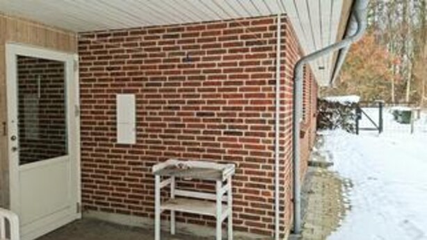 A brick exterior wall, a door, and a small table.