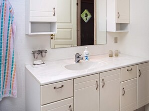 A bathroom with a white sink, a mirror, and a towel rack. - 6 Person Holiday Home in Hurup Thy (Hurup Thy)