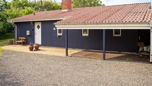 A single-story building with a tiled roof, a chimney, and a covered porch area. - 6 Person Holiday Home in Hurup Thy (Hurup Thy)