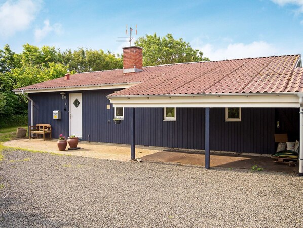 A single-story building with a tiled roof, a chimney, and a covered porch area. - 6 Person Holiday Home in Hurup Thy (Hurup Thy)