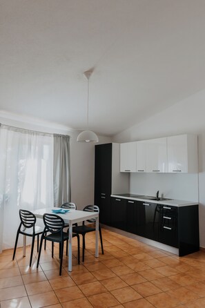 Classic Apartment | Private kitchen | High chair, dining tables - La Smeraldina Resort (Santa Teresa di Gallura)