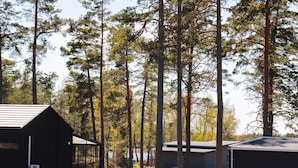A row of cabins with a clear view of the surrounding forest. - 6 Person Holiday Home in Saffle (Saffle)