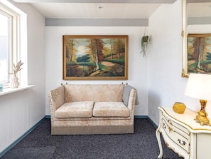 A room with a sofa, a dresser, and two paintings on the wall. - 12 Person Holiday Home in Thisted (Frøstrup)