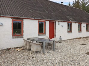 A building with a white exterior, red door, and multiple windows with red frames. - 12 Person Holiday Home in Thisted (Frøstrup)
