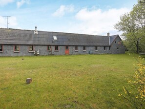 A large, single-story building with a flat roof, multiple windows, and a grassy yard. - 12 Person Holiday Home in Thisted (Frøstrup)