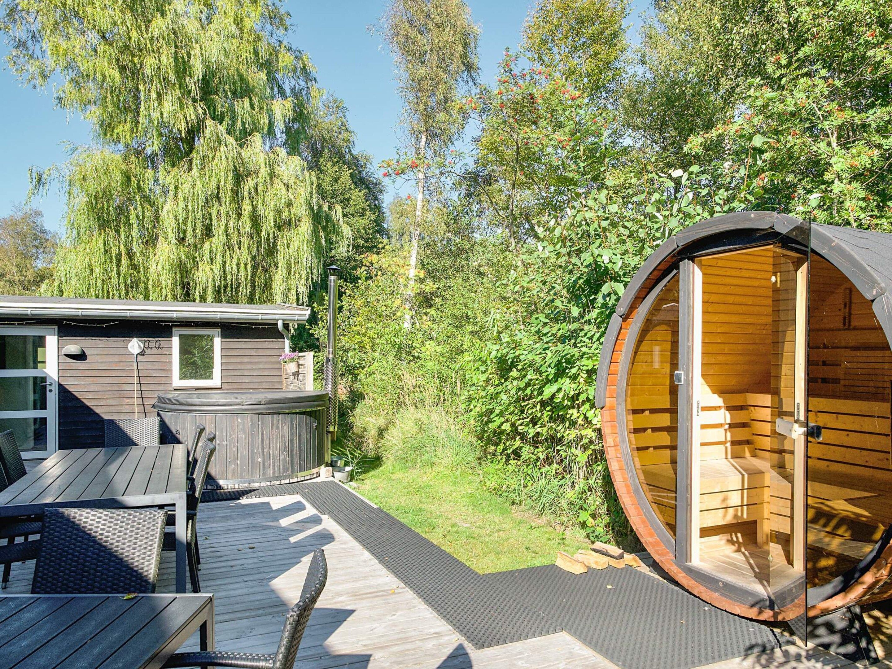 A wooden structure with a hot tub and a deck area.