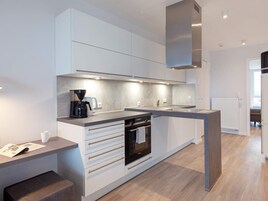 Una cocina moderna con horno empotrado, cafetera y una encimera elegante.