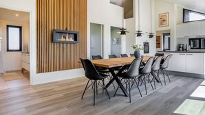 A modern kitchen with white cabinets, a black microwave, and a coffee machine. - 5 Star Holiday Home in Hirtshals (Hirtshals)