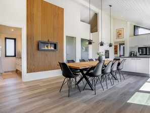 A modern kitchen with white cabinets, a black microwave, and a coffee machine. - 5 Star Holiday Home in Hirtshals (Hirtshals)