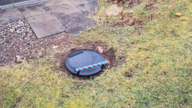 A round, dark-colored object with a colorful rope on a grassy area. - 6 Person Holiday Home in Struer (Struer)