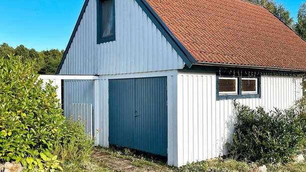 A single-story barn with a red-tiled roof, white walls, and a small window. - 2 Person Holiday Home in Garsnas (Gärsnäs)