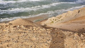 A rocky beach with waves crashing onto the shore.