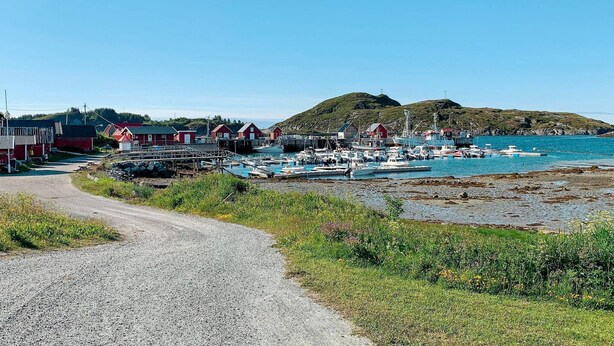 A coastal village with a gravel road leading to a harbor filled with boats. - 6 Person Holiday Home in Meloy (Meloy)