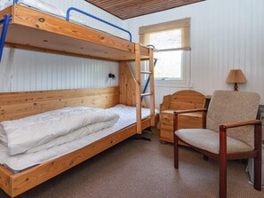 A bunk bed with a ladder, a wooden chair, and a window with blinds. - 4 Person Holiday Home in Ans By (Ans)