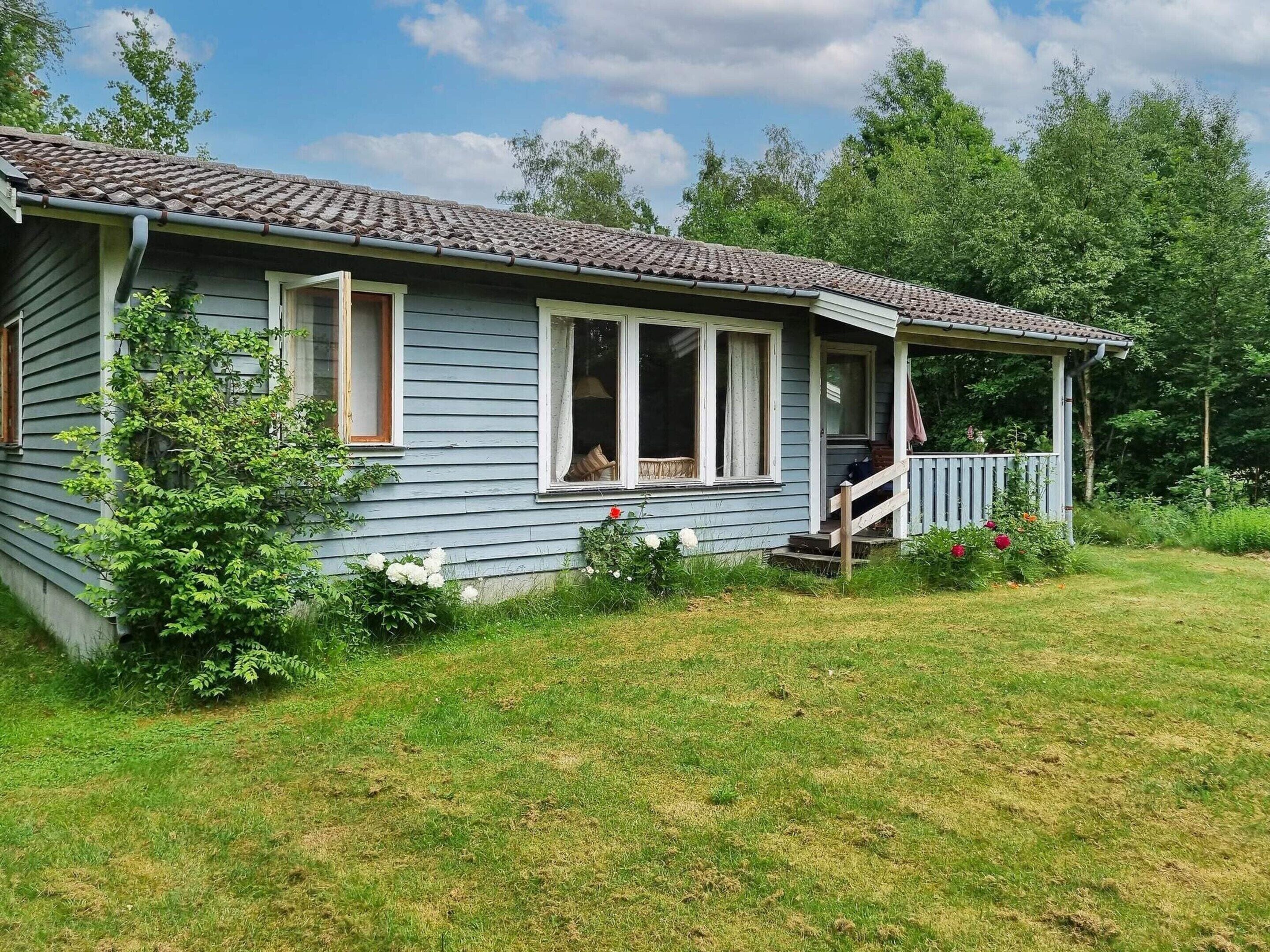 A single-story house with a porch and a small front yard.