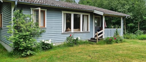 A single-story house with a porch and a small front yard.