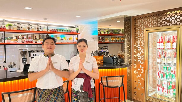 A bar area with a counter, shelves with bottles, and a refrigerator with drinks. - d'primahotel Airport Jakarta Terminal 3 Wellness Center (Tangerang)