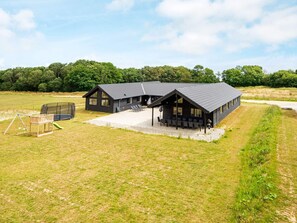 A modern building with a covered patio area and a playground. - 5 Star Holiday Home in Sydals (Sydals)