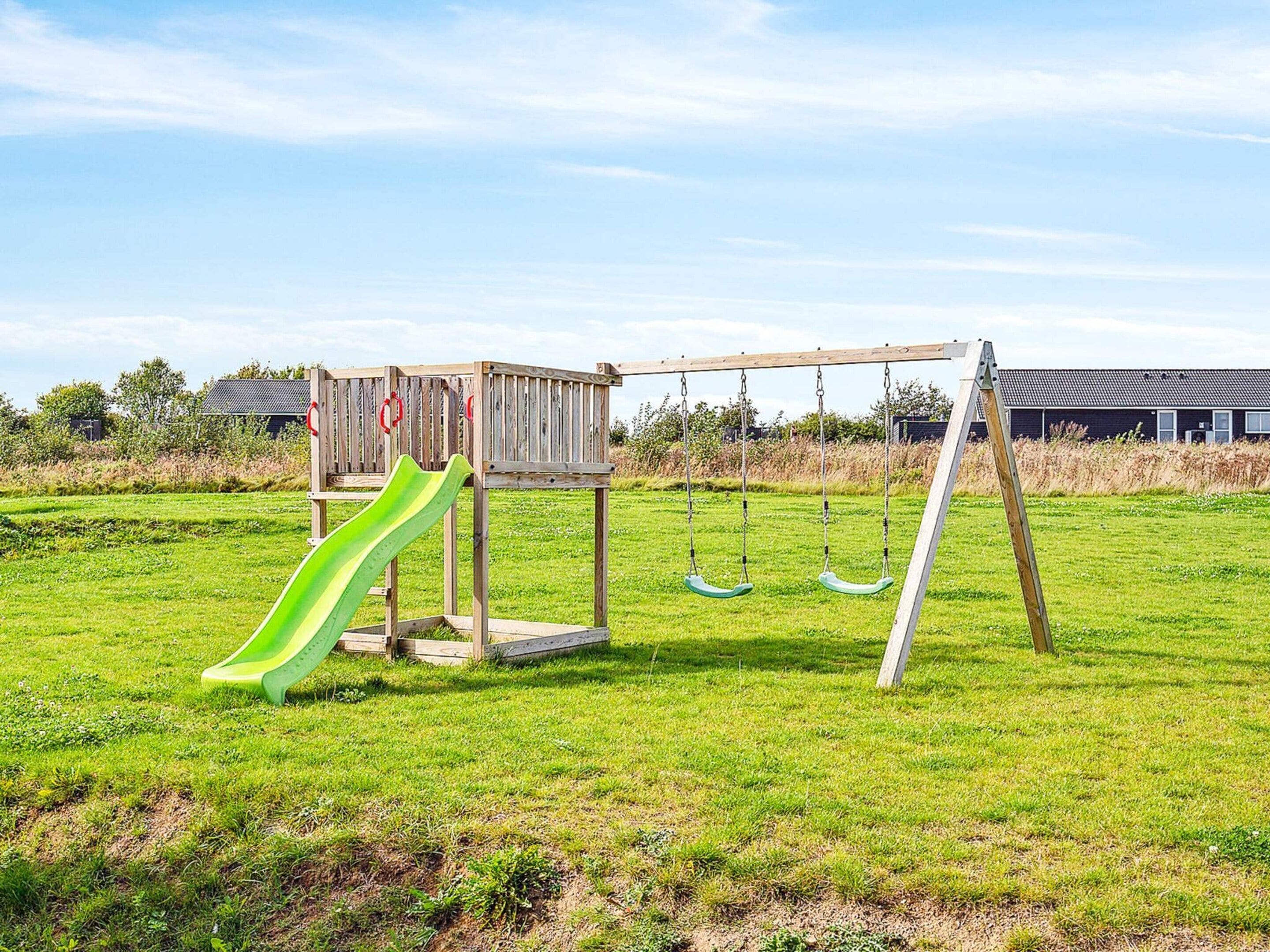 A playground with a slide, swings, and a climbing structure.