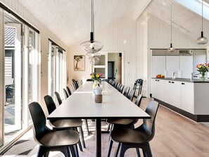 Enjoy meals in this spacious dining area with a long table and comfortable seating for all.