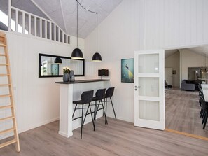 A modern interior with a kitchen area, dining space, and an open-plan living area. - 5 Star Holiday Home in Sydals (Sydals)
