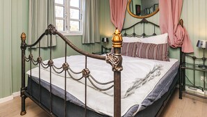 A room with a bed, a window, a mirror, and a bedside table. - 8 Person Holiday Home in Gilleleje-by Traum (Gilleleje)