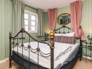 A room with a bed, a window, a mirror, and a bedside table. - 8 Person Holiday Home in Gilleleje (Gilleleje)