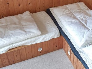A bunk bed with white bedding and a grey carpeted floor. - 6 Person Holiday Home in Sydals (Sydals)